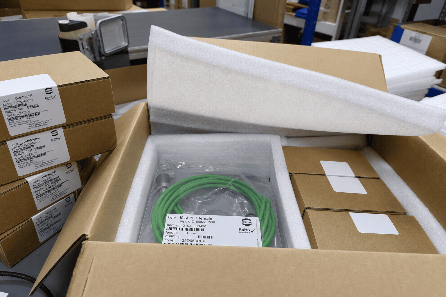 Packing scene with cartons, foam, and anti-static packaging